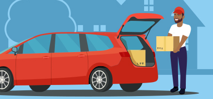 Någon som tar ut lådor ur bagageutrymmet på sin bil